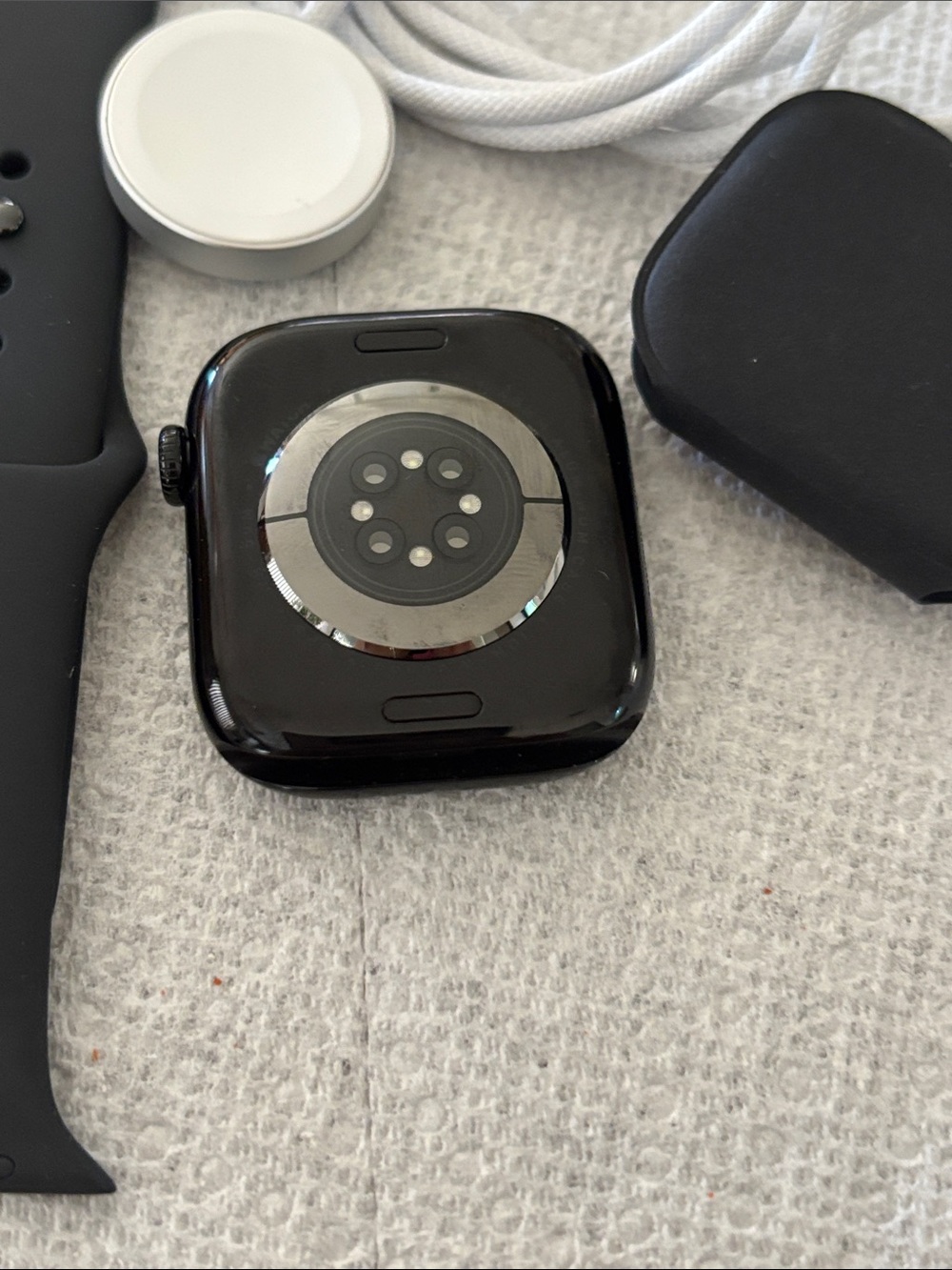 Apple Watch with Black Sport Band and White Charging Cable - Picture 2 of 2